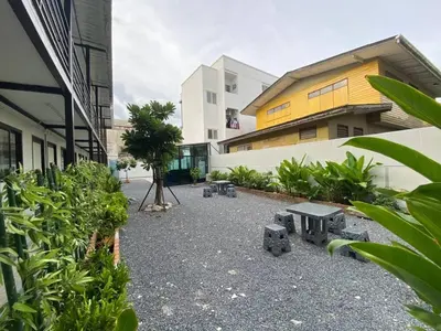 a courtyard with benches in front of a building at P29 in Bangkok