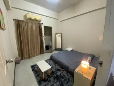 a bedroom with a bed and a table and a window at P29 in Bangkok