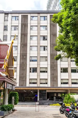 a building with motorcycles parked in front of it at 56 Surawong Hotel Bangkok in Bangkok
