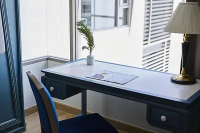 a desk with a potted plant on top of it at 56 Surawong Hotel Bangkok in Bangkok