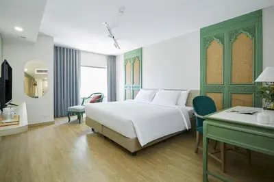 a hotel room with a bed and a desk and a desk at 56 Surawong Hotel Bangkok in Bangkok