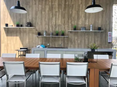 a dining room with a wooden table and white chairs at Chapter One Eco-Modern Suite (\u66fc\u8c37\u9ad8\u7aef\u9152\u5e97\u516c\u5bd3\uff09 in Bangkok