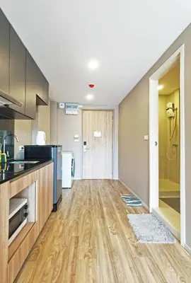 a kitchen with wooden flooring and a counter top at Blossom Sathorn Hospitality \uff08\u66fc\u8c37\u9ad8\u7aef\u9152\u5e97\u516c\u5bd3\uff09 in Bangkok