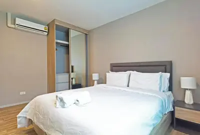 a bedroom with a large white bed with towels on it at Blossom Sathorn Hospitality \uff08\u66fc\u8c37\u9ad8\u7aef\u9152\u5e97\u516c\u5bd3\uff09 in Bangkok