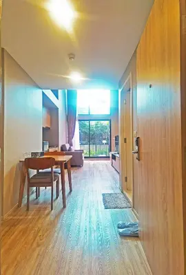 a dining room and living room with a table at Blossom Sathorn Hospitality \uff08\u66fc\u8c37\u9ad8\u7aef\u9152\u5e97\u516c\u5bd3\uff09 in Bangkok
