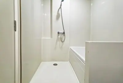 a white bathroom with a shower with a toilet at Blossom Sathorn Hospitality \uff08\u66fc\u8c37\u9ad8\u7aef\u9152\u5e97\u516c\u5bd3\uff09 in Bangkok