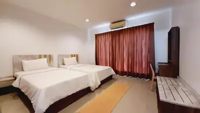 a hotel room with two beds and a window at City Plaza Nana Hotel in Bangkok