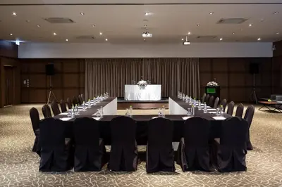 a conference room with a long table and chairs at S Ratchada Leisure Hotel in Bangkok