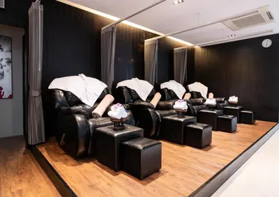 a group of black leather chairs in a room at S Ratchada Leisure Hotel in Bangkok