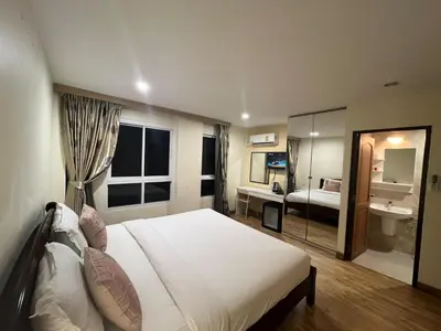 a bedroom with a bed and a bathroom with a sink at V Check inn Sukhumvit 22 in Bangkok
