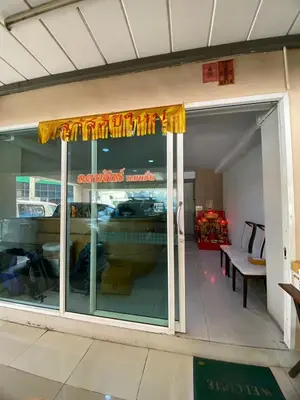 a store front window with a sign on it at Ladapan Mansion in Nonthaburi