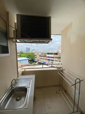 a bathroom with a sink and a window with a view at Ladapan Mansion in Nonthaburi