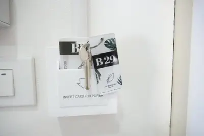 a sign on a door with a first clock on it at ATC Residence in Bang Su