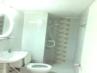 a bathroom with a shower and a toilet and a sink at Comfortable studio T8 Impact Bangkok Thailand in Nonthaburi