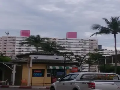 a car parked in front of a gas station with tall buildings at Comfortable studio T8 Impact Bangkok Thailand in Nonthaburi