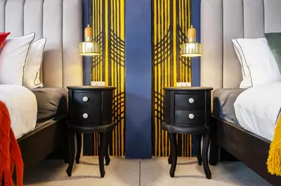 a bedroom with two twin beds and two night stands at The Mellow at Silom in Bangkok