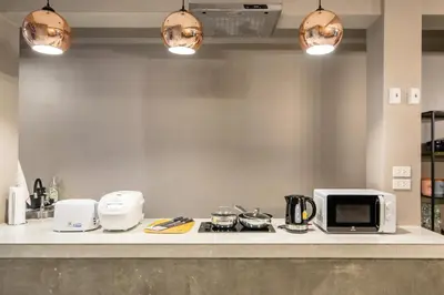 a kitchen with a counter top with a microwave at The Mellow at Silom in Bangkok