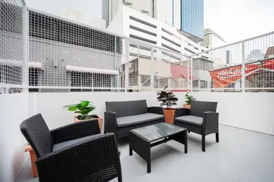 a room with chairs and a table in a building at The Mellow at Silom in Bangkok