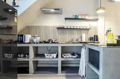 a kitchen with a counter in a room at The Mellow at Thong Lo in Bangkok
