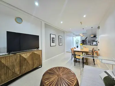 a living room with a large television and a table at The Mellow at Thong Lo in Bangkok