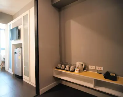 a room with a counter and a refrigerator in a room at iSanook Bangkok in Bangkok