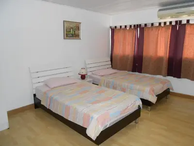 a bedroom with two beds in a room at MT-Room in Bangkok