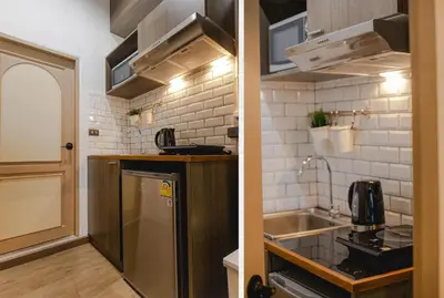 a small kitchen with a sink and a refrigerator at Krung Boutique Hotel in Bangkok