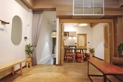 a living room with a couch and a table at Krung Boutique Hotel in Bangkok