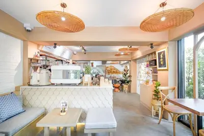 a living room with a kitchen and a table at Krung Boutique Hotel in Bangkok