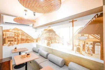 a restaurant with a mural of a street at Krung Boutique Hotel in Bangkok