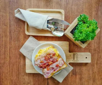 a plate of food on a table with a plate of food at Krung Boutique Hotel in Bangkok