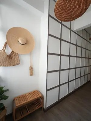 a straw hat and a bench in a room at Krung Boutique Hotel in Bangkok
