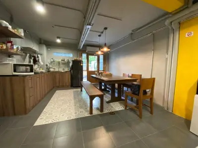 a kitchen and dining room with a table and chairs at Bangpho Story in Bangkok