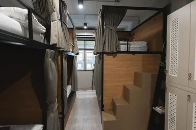 a small room with bunk beds and stairs in it at Bangpho Story in Bangkok