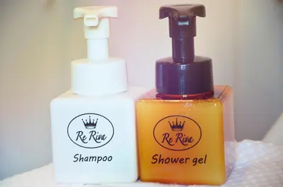 two bottles of soap sitting next to each other at Re Riva in Ban Bang Bamru