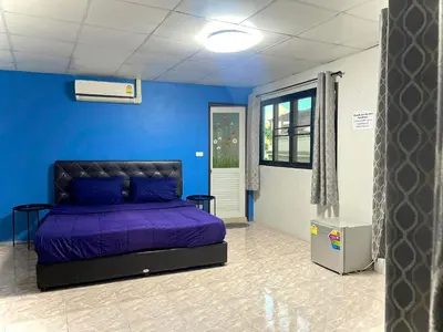 a bedroom with a purple bed in a blue wall at U&D guest house in Bangkok