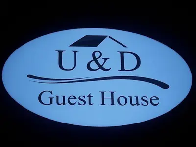 a sign for a guest house with a graduation cap at U&D guest house in Bangkok