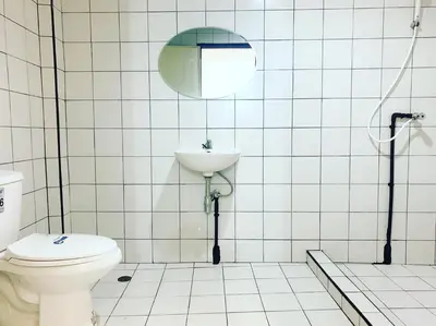 a bathroom with a toilet and a sink at Gfeel Hostel in Bangkok