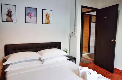 a bedroom with a bed and some pictures on the wall at Gfeel Hostel in Bangkok