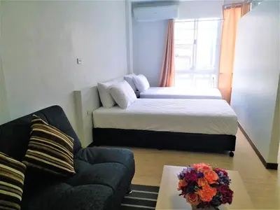 a small room with a bed and a couch at DD Garden Apartment 2 in Bangkok