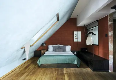 a bedroom with a bed and a staircase at B House 49 Bangkok in Bangkok