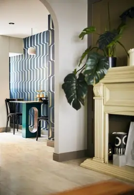 a living room with a table and a fireplace at B House 49 Bangkok in Bangkok