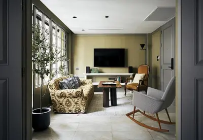 a living room with a couch and a tv at B House 49 Bangkok in Bangkok