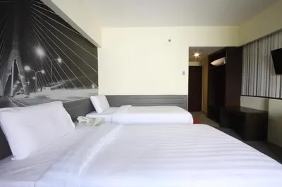 a hotel room with two beds and a television at Royal Delight Hotel in Bangkok