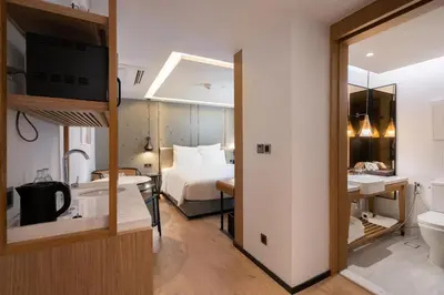 a hotel room with a bed and a bathroom at Homm Sukhumvit34 Bangkok in Bangkok