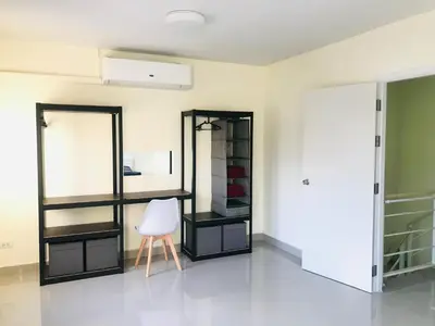 a room with a mirror and a chair in it at Impact MT House in Ban Bang Phang