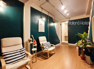 a room with two chairs and a sign for a boutique house at Station8 Hostel in Bangkok