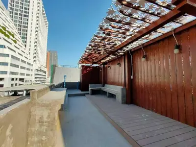 a building with a roof with a bench on it at Station8 Hostel in Bangkok