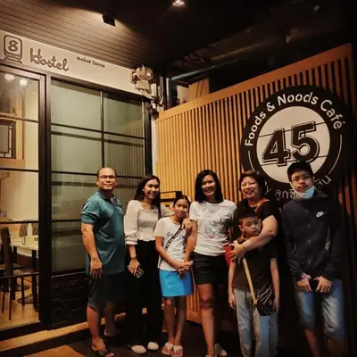 a group of people standing in front of a store at Station8 Hostel in Bangkok