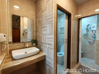 a bathroom with a sink and a shower and a toilet at Station8 Hostel in Bangkok